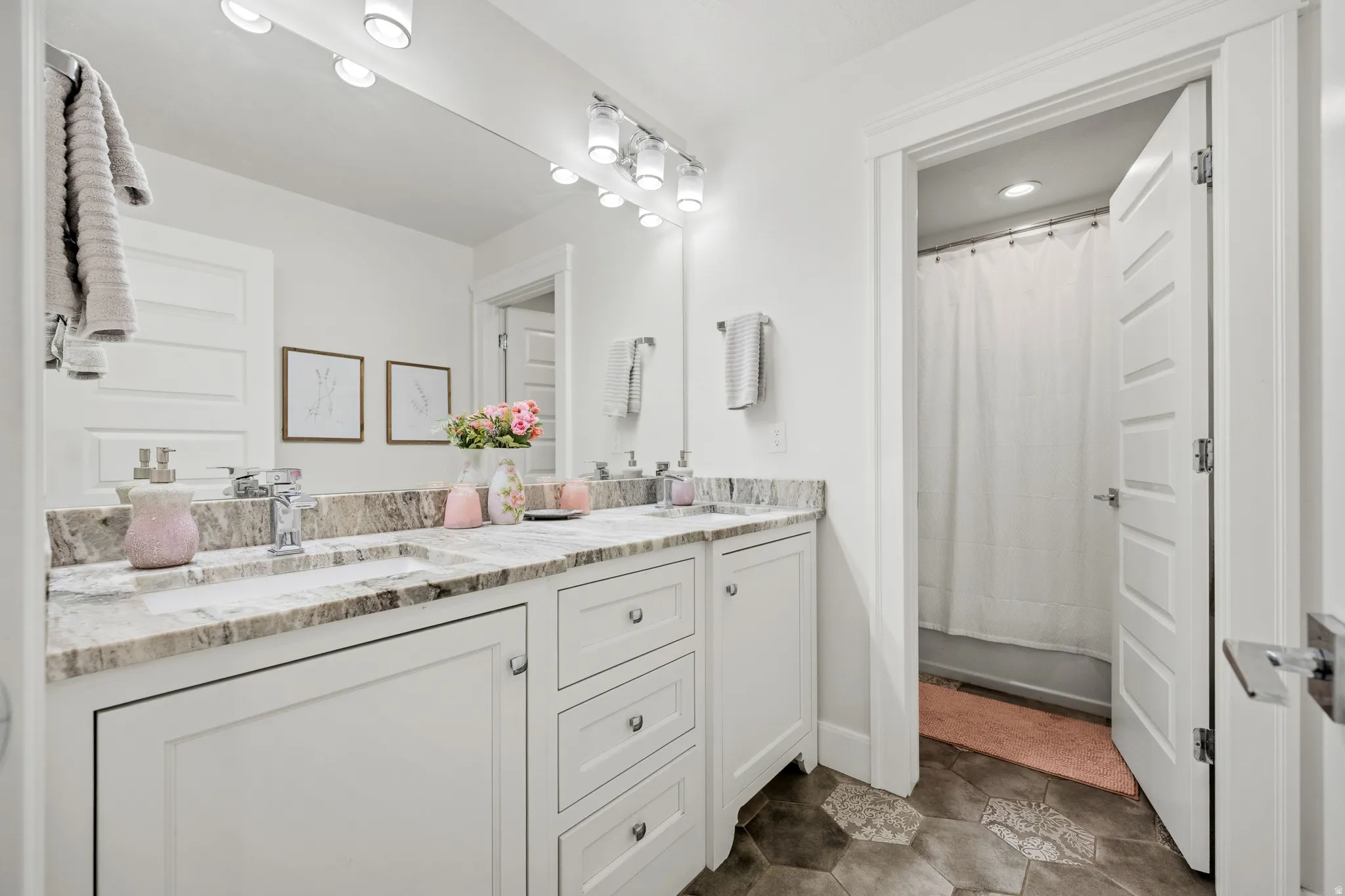 Dual vanity with undermount sinks, stone-finish countertop, and chrome faucets