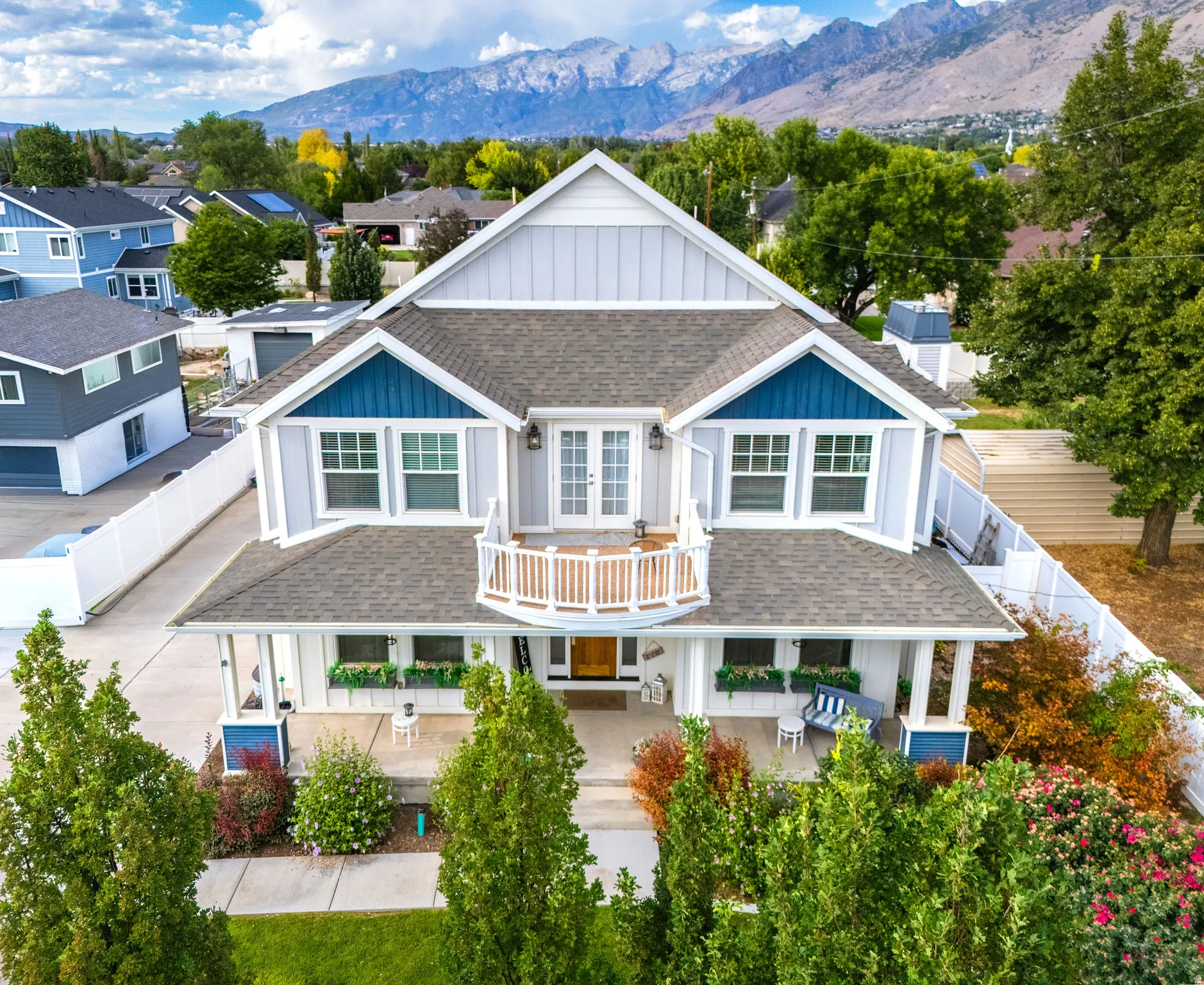 Gable roof design with light gray siding and blue accents