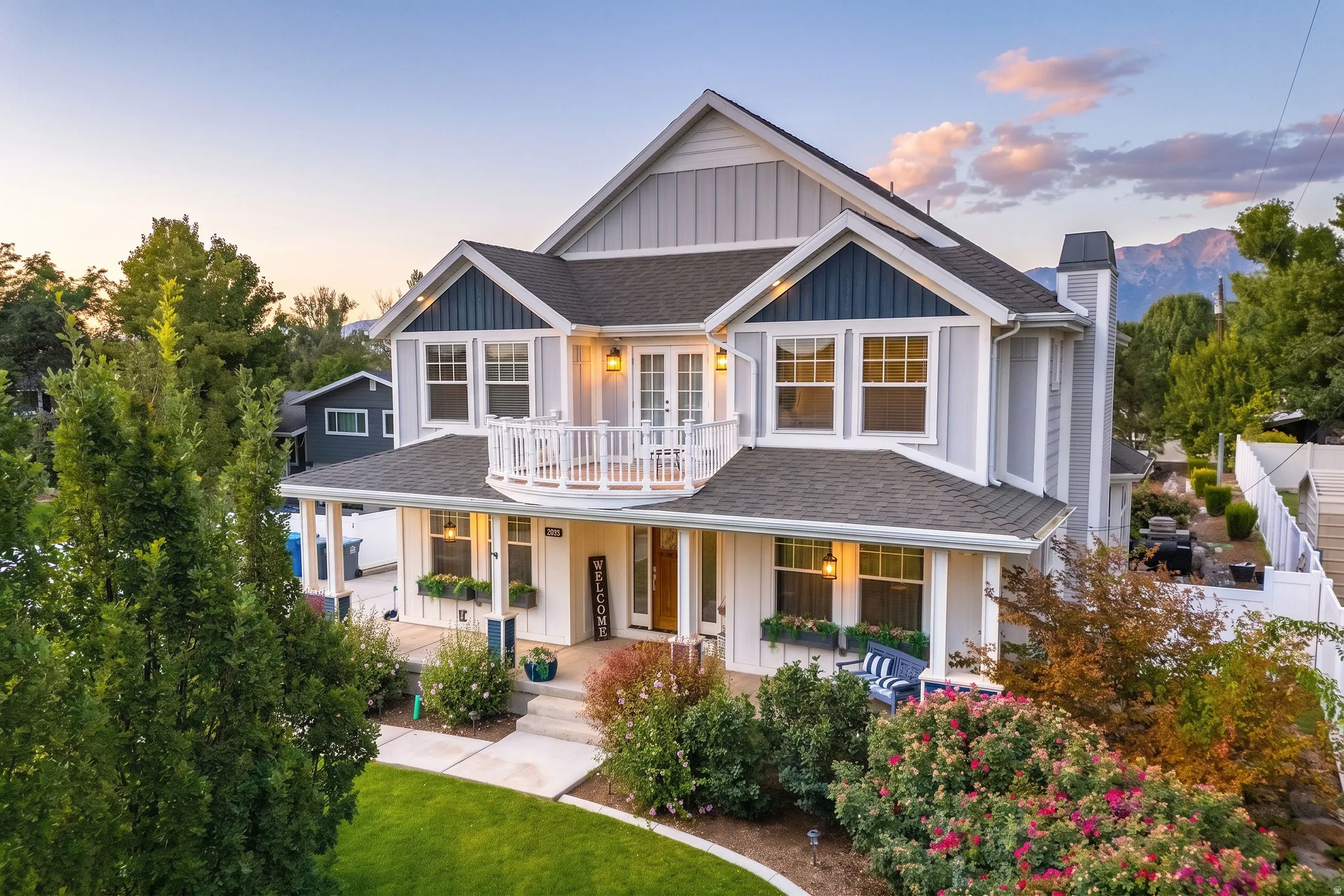 Two-story residence with a covered front porch and an upper-level balcony