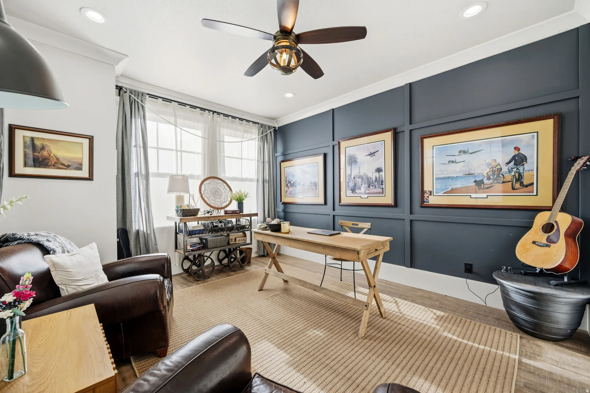 Recessed lighting, ceiling fan with light fixture, decorative wall paneling, and wood-finish flooring