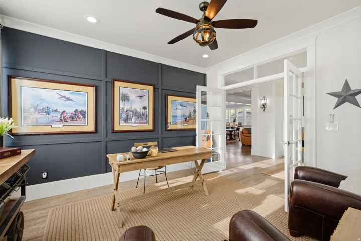 Recessed lighting, ceiling fan with integrated light, paneled accent wall, French doors, and wood-finish flooring
