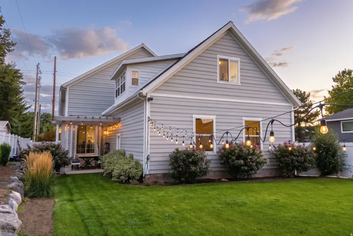 Expansive green lawn with established shrubbery and landscaping