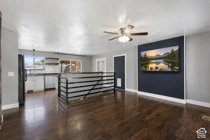 Open-concept living area with dark wood-finish flooring