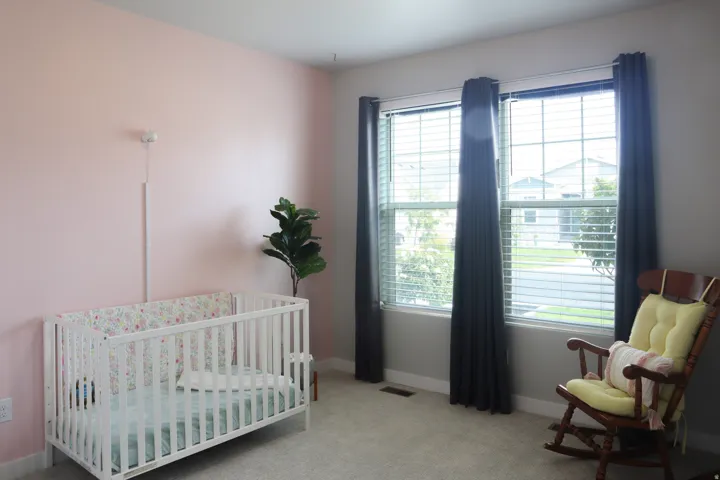 Dual windows with horizontal blinds, providing ample natural illumination