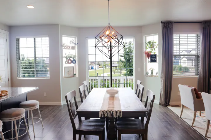 Formal dining area featuring wood-finish flooring and a contemporary pendant light fixture