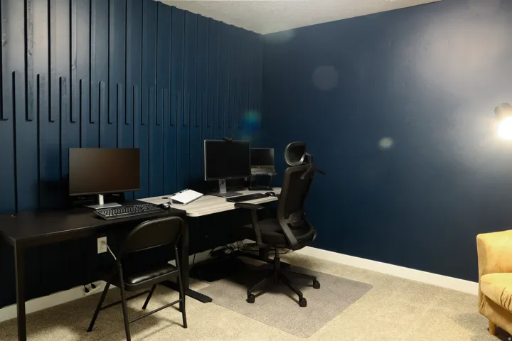 Accent wall featuring vertical wood paneling and a dark blue finish