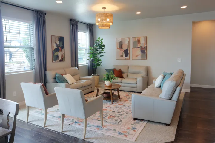 Recessed lighting, wood-finish flooring, and a decorative woven light fixture