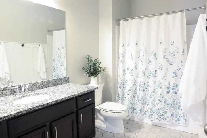 Dark wood-finish vanity with a single basin sink and stone countertop