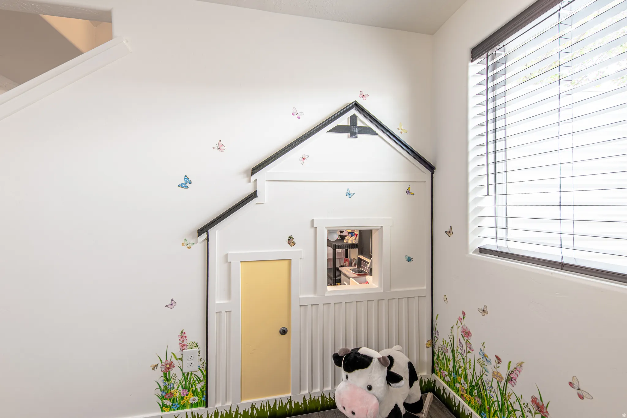 Built-in wall feature with a gabled roofline and window cutout