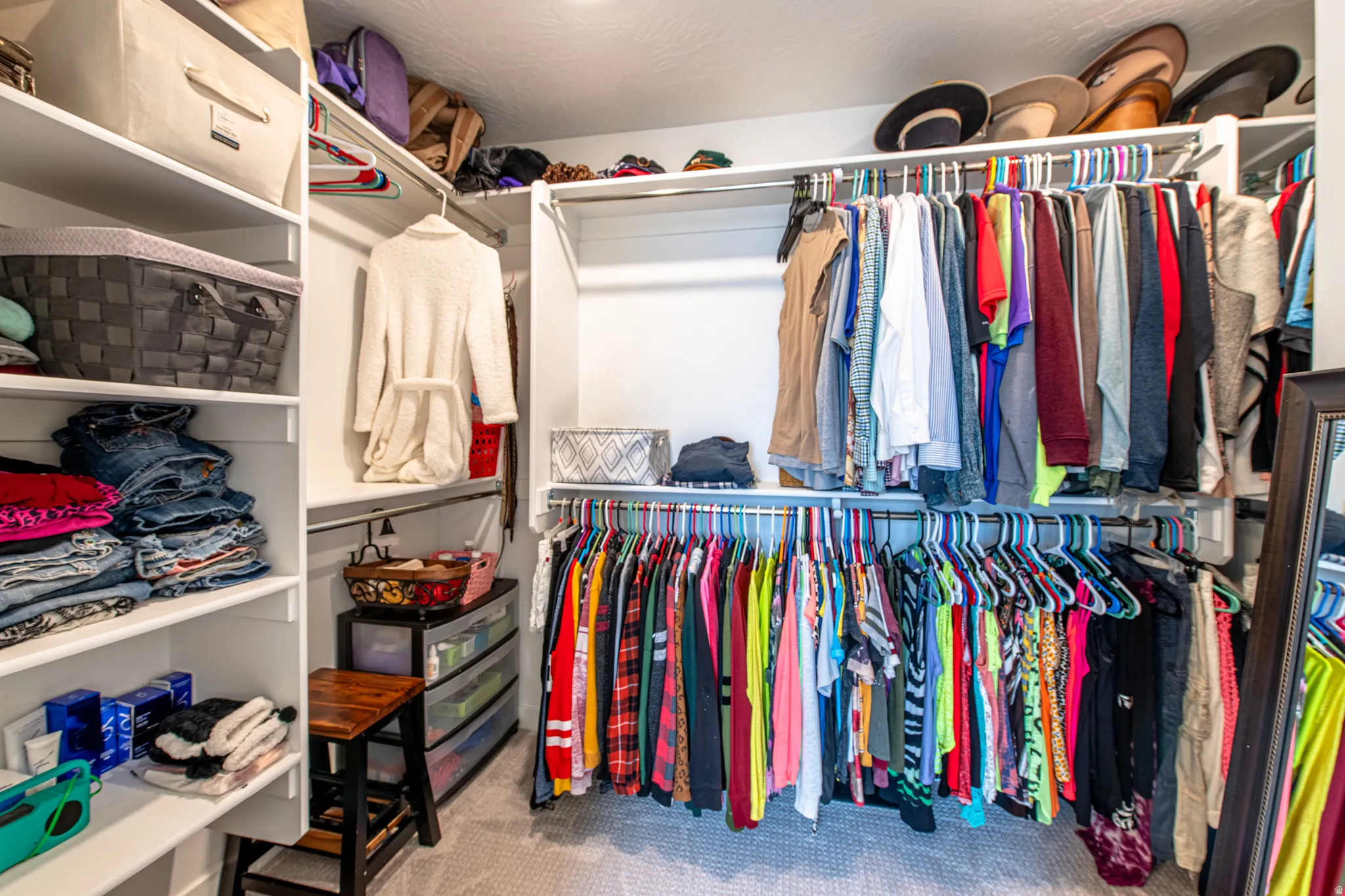 Built-in closet system featuring multiple hanging rods, extensive shelving, and integrated storage solutions