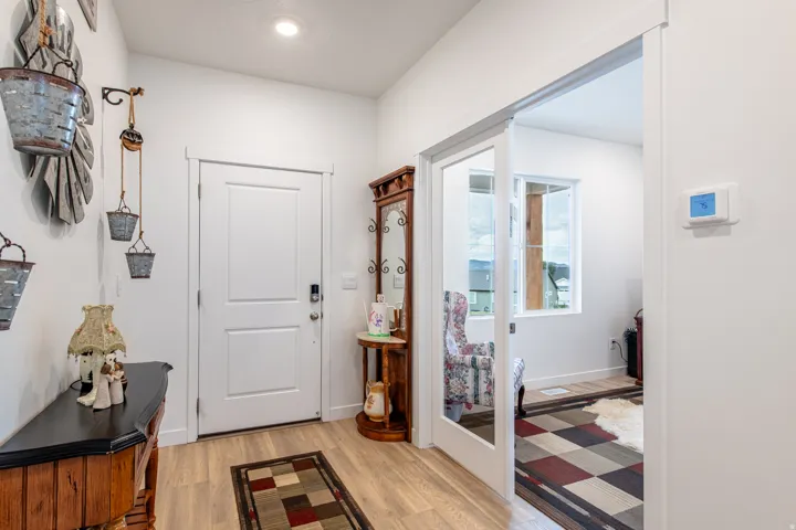 Entryway featuring wood-finish flooring and a white paneled door
