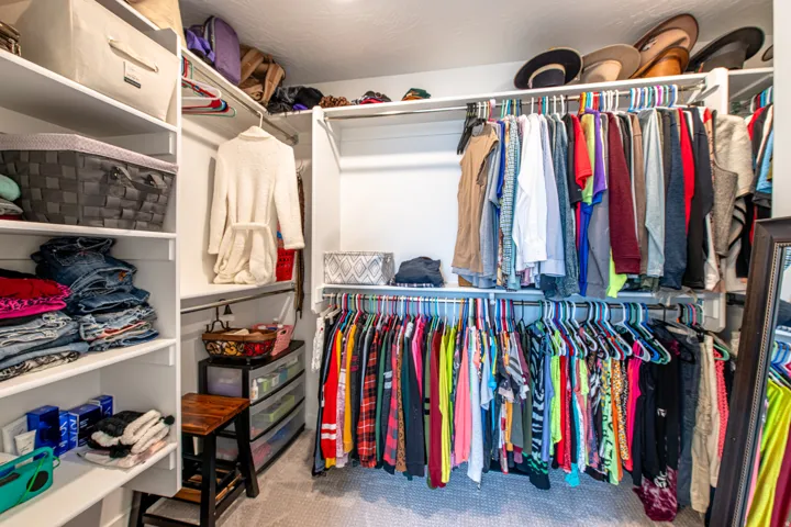 Built-in closet system featuring multiple hanging rods, extensive shelving, and integrated storage solutions