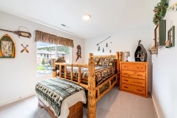 Expansive window, neutral wall paint, recessed lighting, and soft carpet flooring