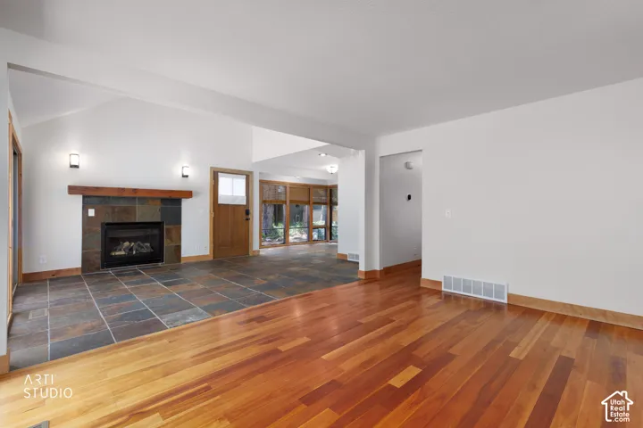 Vaulted ceiling over a slate tile fireplace with a wood mantle