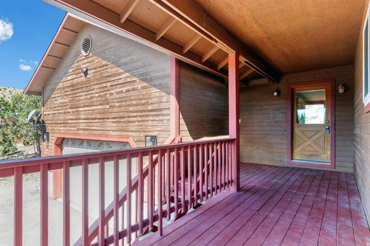 Covered porch with wood-finish decking and wood railing