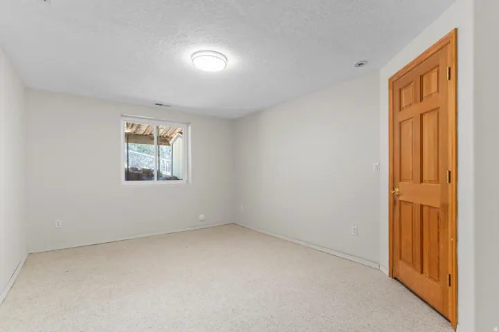 Neutral-toned walls complement the light-colored carpeting