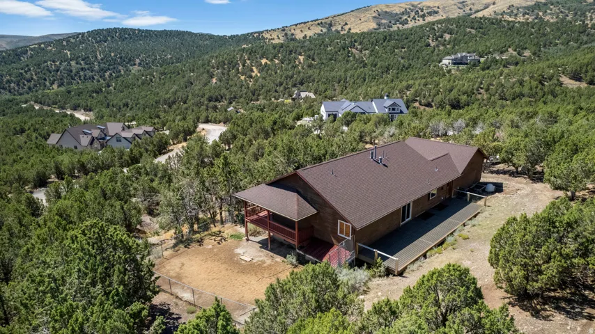 Expansive property featuring a brown exterior, a covered deck, and an open deck