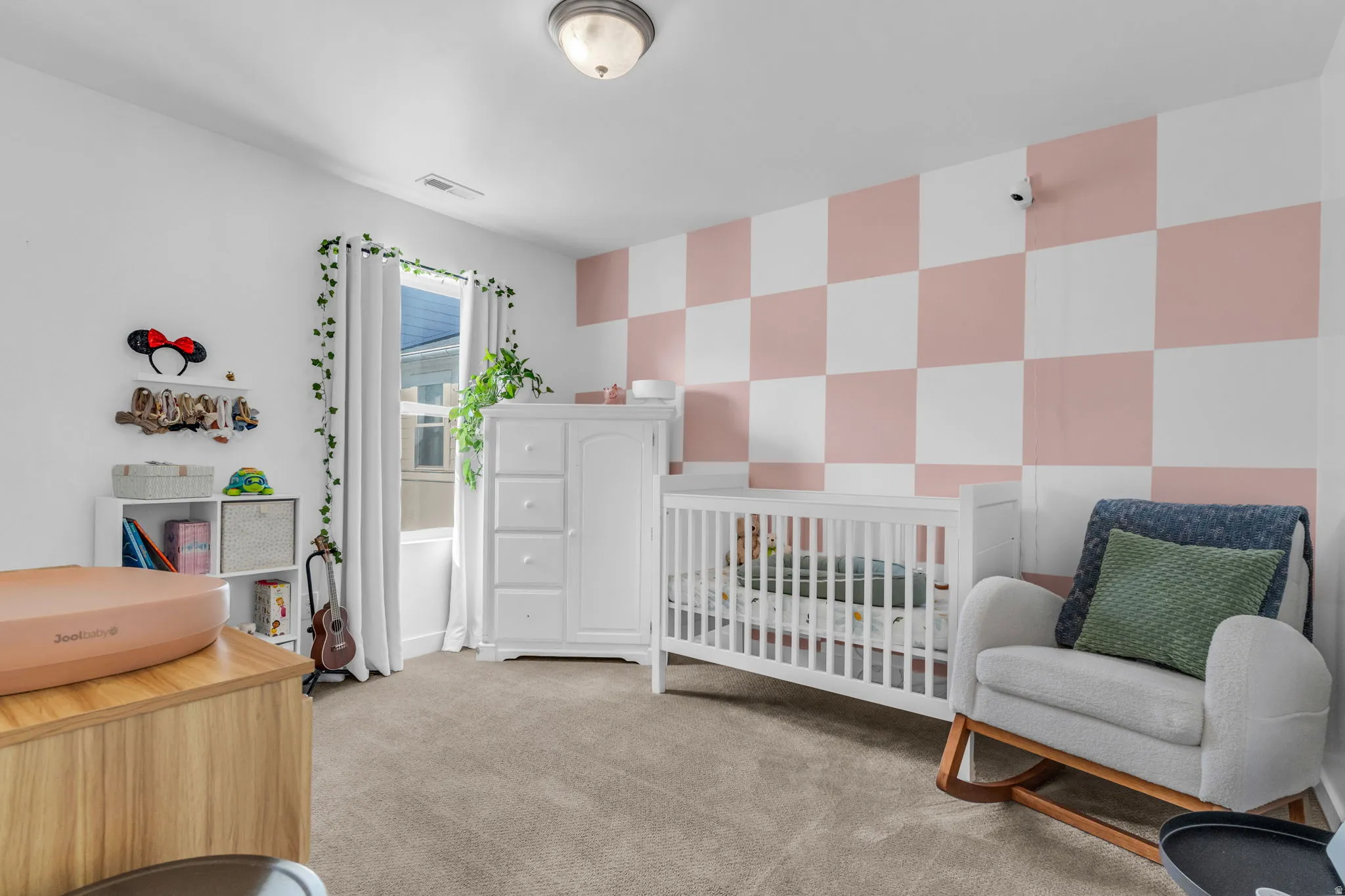 Bright room with carpeted flooring, a window with vertical blinds, and a flush mount ceiling light fixture