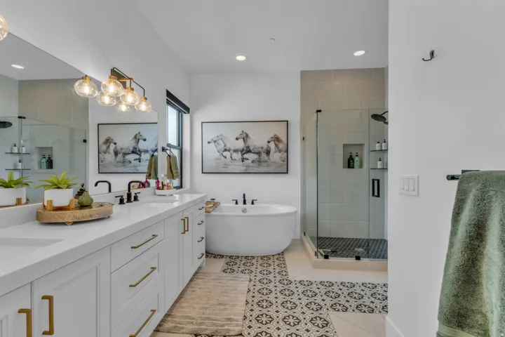 Dual vanity with white cabinetry and gold-tone hardware