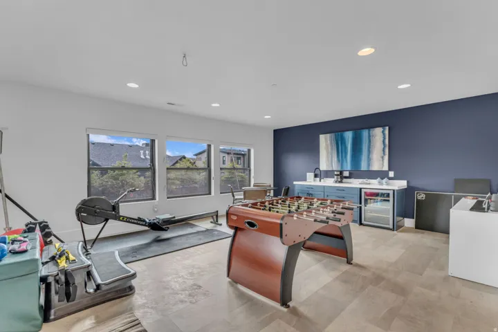 Spacious room with wood-finish flooring, recessed lighting, and multiple windows