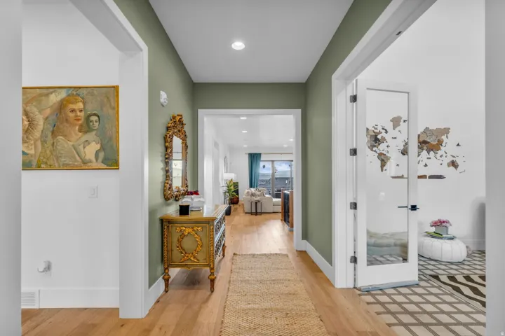 Hallway with wood-finish flooring, recessed lighting, and sage green wall paint