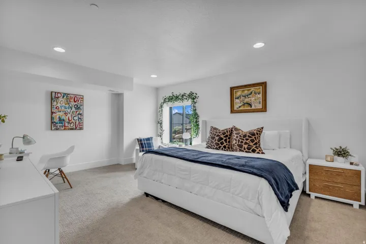 Recessed lighting, light gray carpet, and a window with white trim