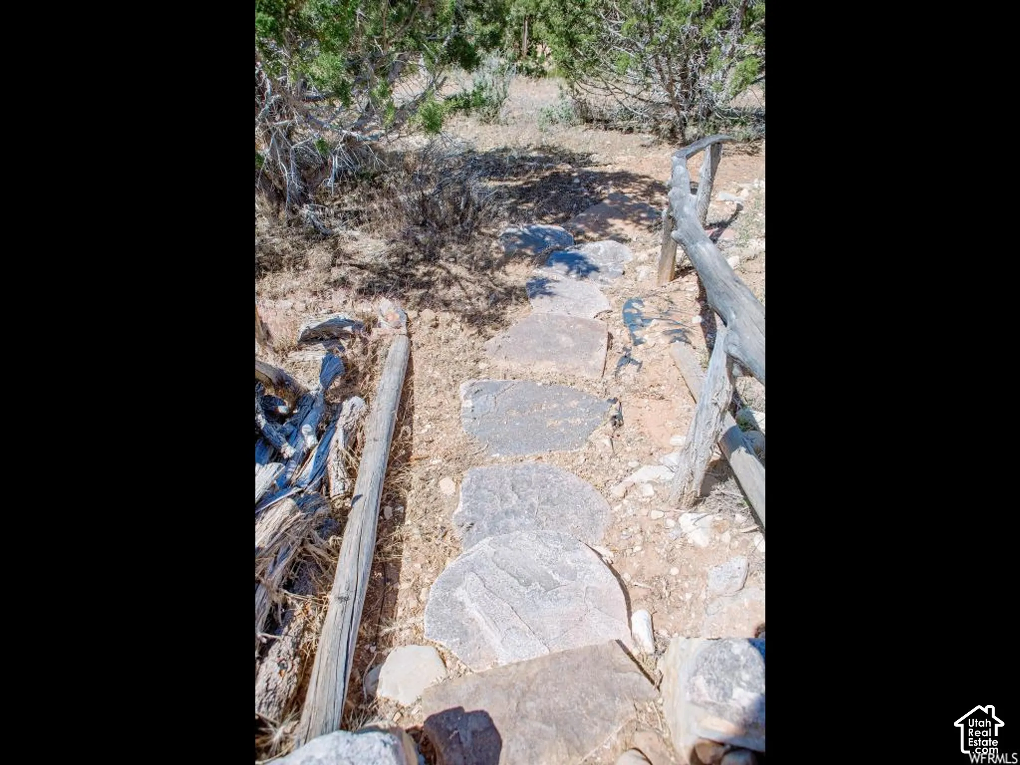 Stone stepping-stone pathway with natural wood fencing