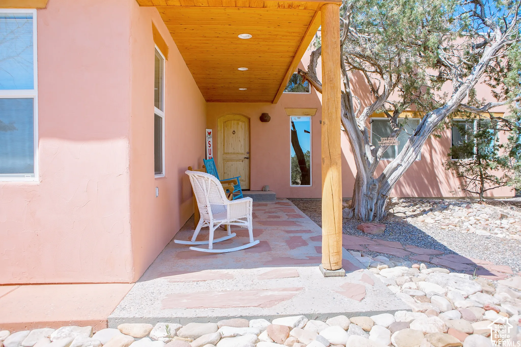 Stucco exterior with wood-plank soffit