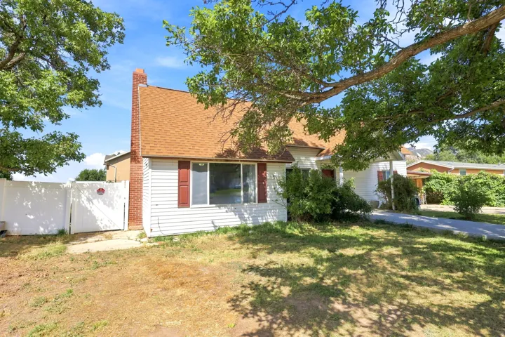 White siding exterior with a red shingle roof