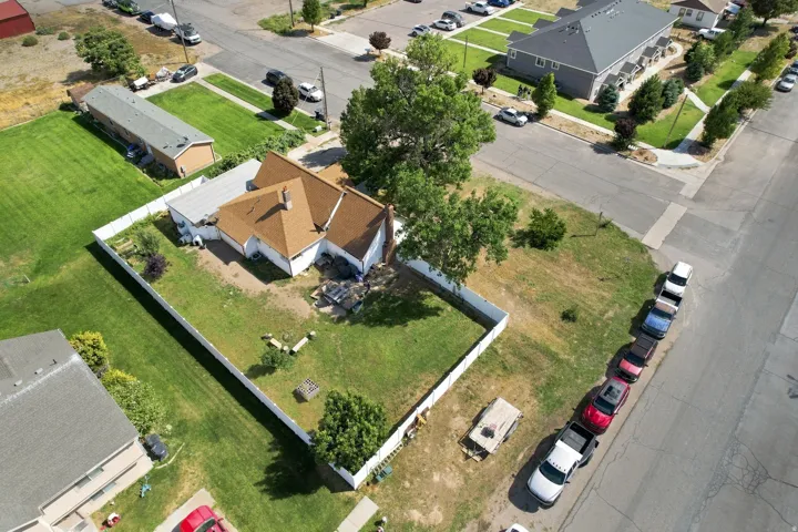 Expansive corner lot with a white privacy fence