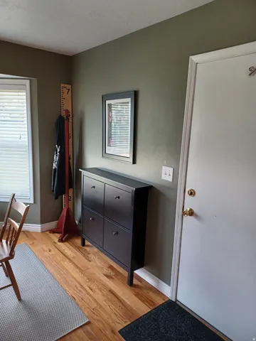 Hardwood flooring with a white trim baseboard