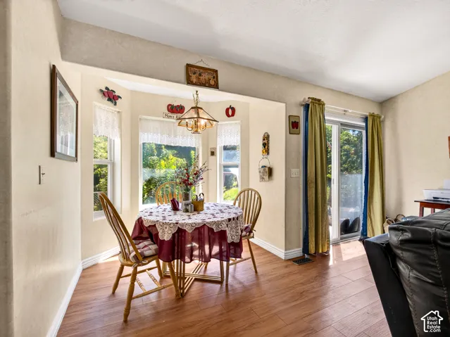 Secondary dining, LVP flooring, a sliding glass door, and a built-in ceiling light fixture