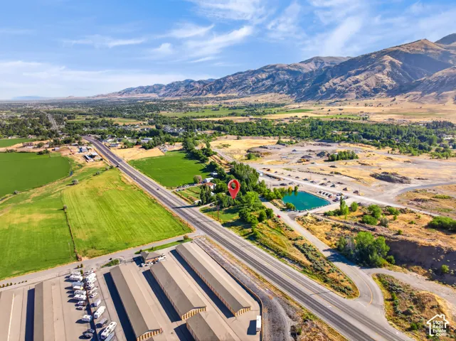 Ariel view of property with mountain backdrop