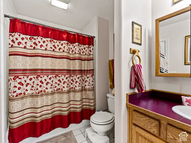 2nd bathroom with wood-finish cabinetry, red countertop, and integrated sink