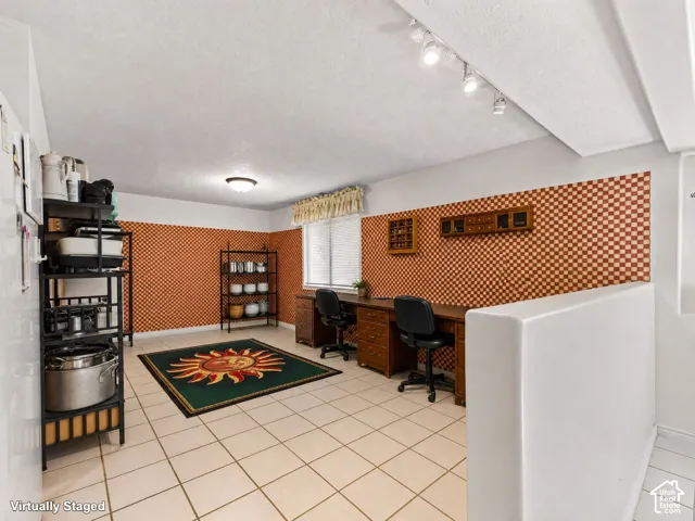 Basement office area, tile flooring, recessed lighting, shelving, track lighting, and a window with blinds