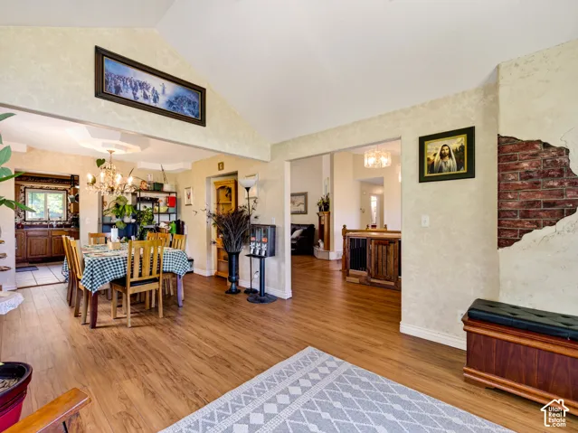 View from living room to dining room, LVP flooring, vaulted ceiling, and recessed lighting