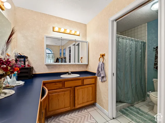 Primary bathroom with vanity, wood-finish cabinetry, integrated sink, and an overhead medicine cabinet with mirror