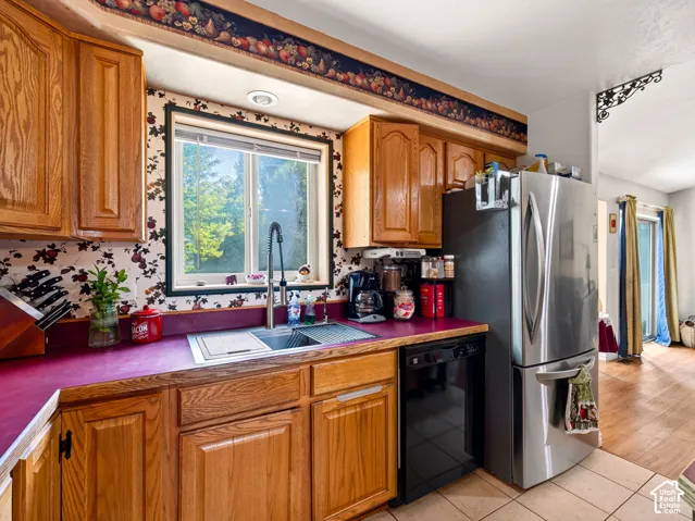 Kitchen featuring wood cabinetry, stainless steel sink, and recessed lighting