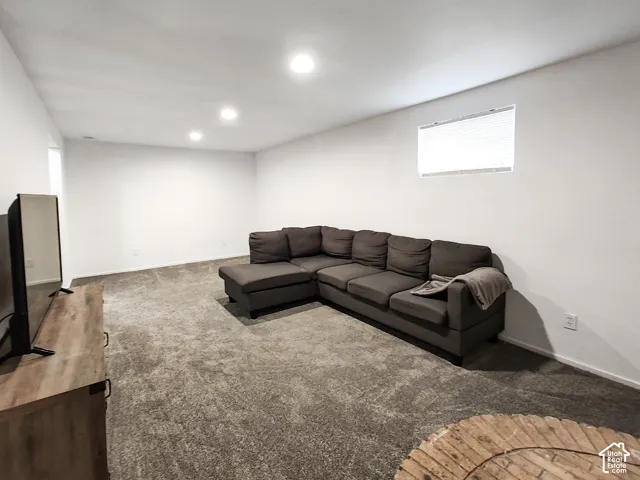 Spacious room featuring neutral wall paint, recessed ceiling lighting, and plush carpeting