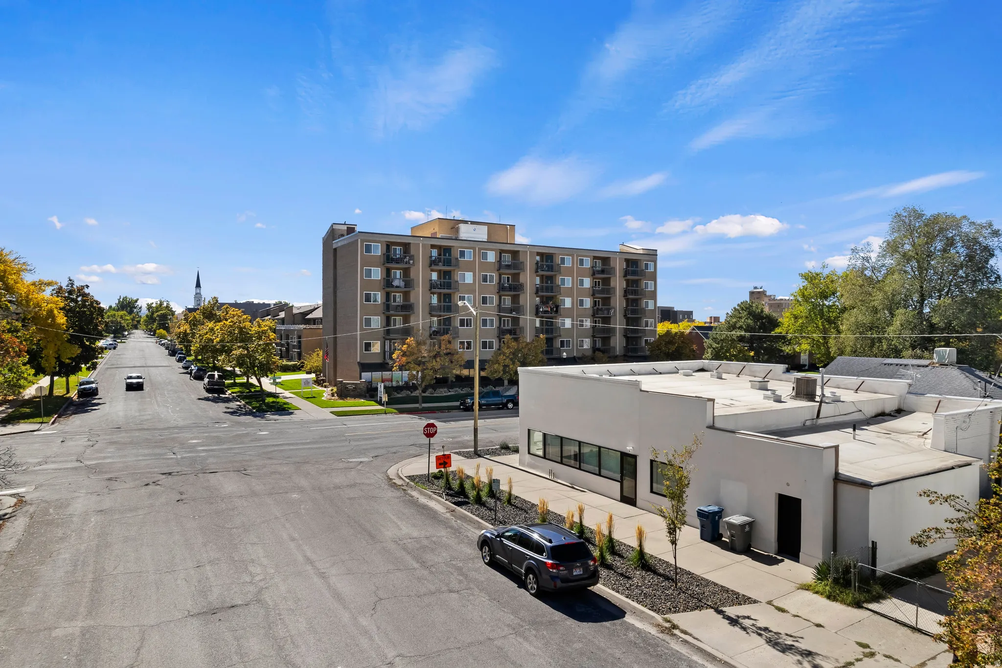 Commercial property with a flat roofline, large window frontage, and a stucco exterior finish
