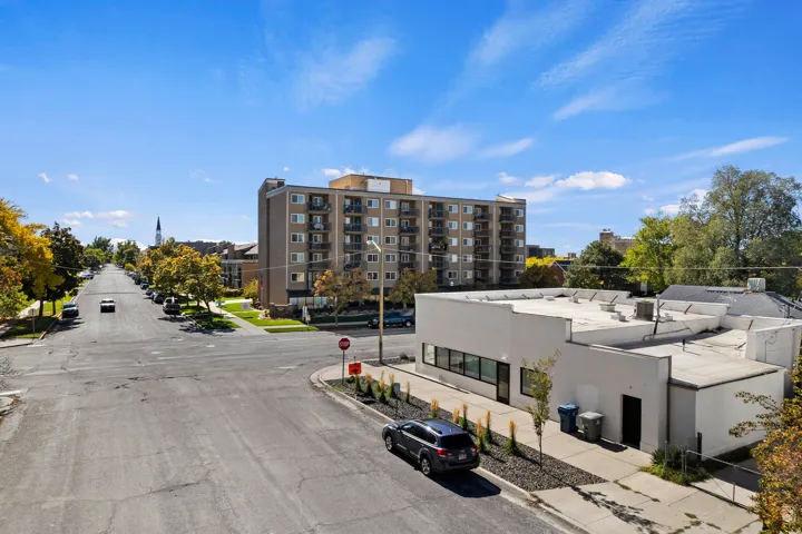 Commercial property with a flat roofline, large window frontage, and a stucco exterior finish