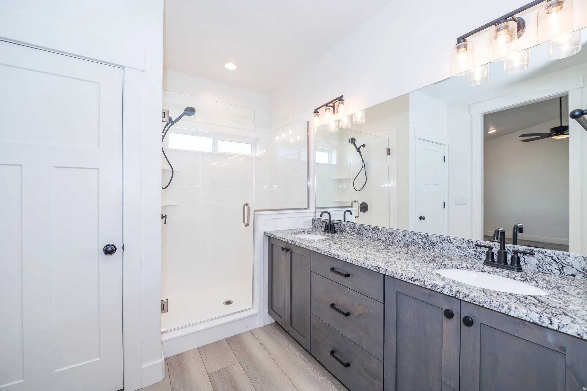 Dual vanity with stone-finish countertop, undermount sinks, and matte black fixtures