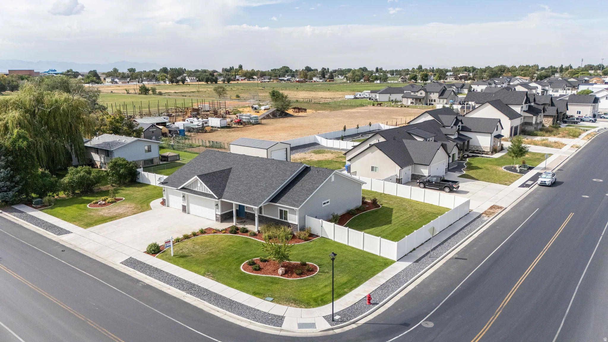 Contemporary ranch-style residence featuring a prominent gable roof, an attached two-car garage, and a concrete driveway