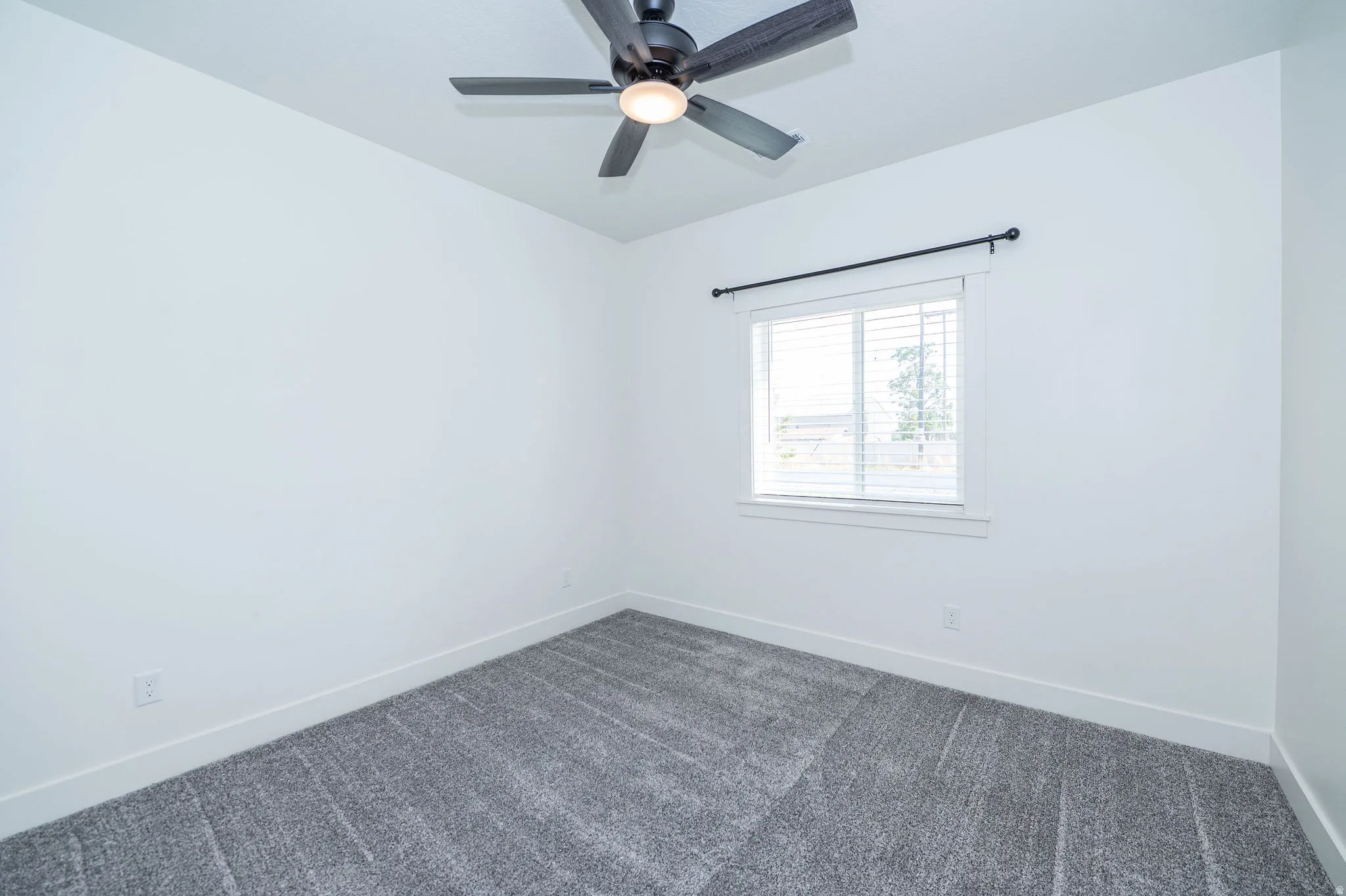 Light gray textured carpeting with crisp white walls
