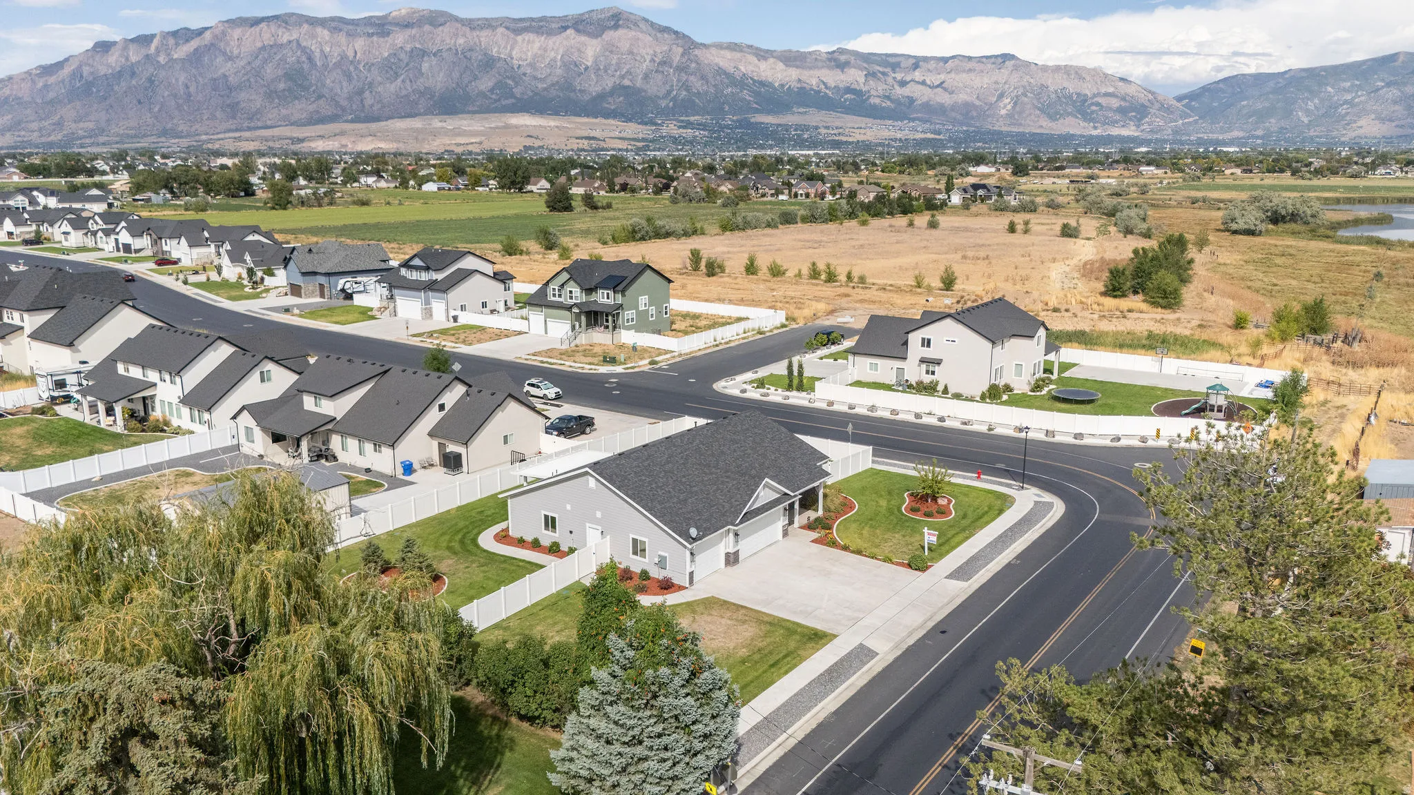 Newly constructed residential properties featuring paved roads and curb appeal