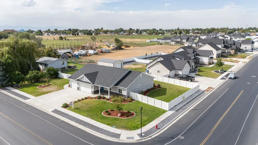 Contemporary ranch-style residence featuring a prominent gable roof, an attached two-car garage, and a concrete driveway