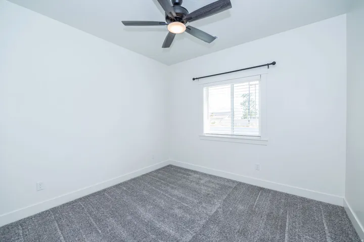 Light gray textured carpeting with crisp white walls