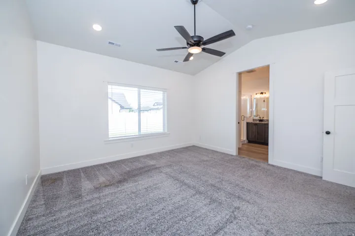 Vaulted ceiling with recessed lighting and a ceiling fan