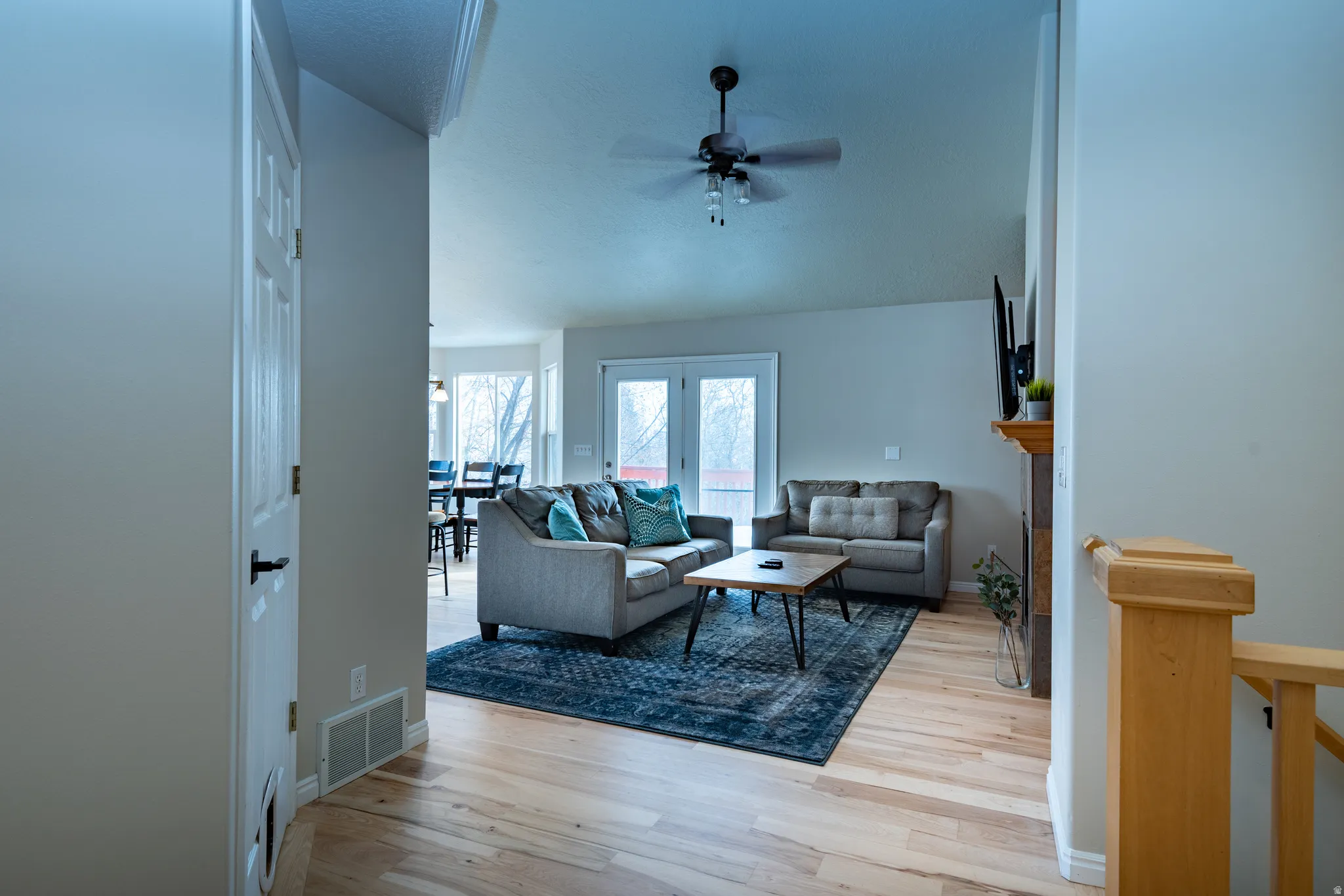 Hardwood-finish flooring, recessed lighting, and a ceiling fan with integrated lighting
