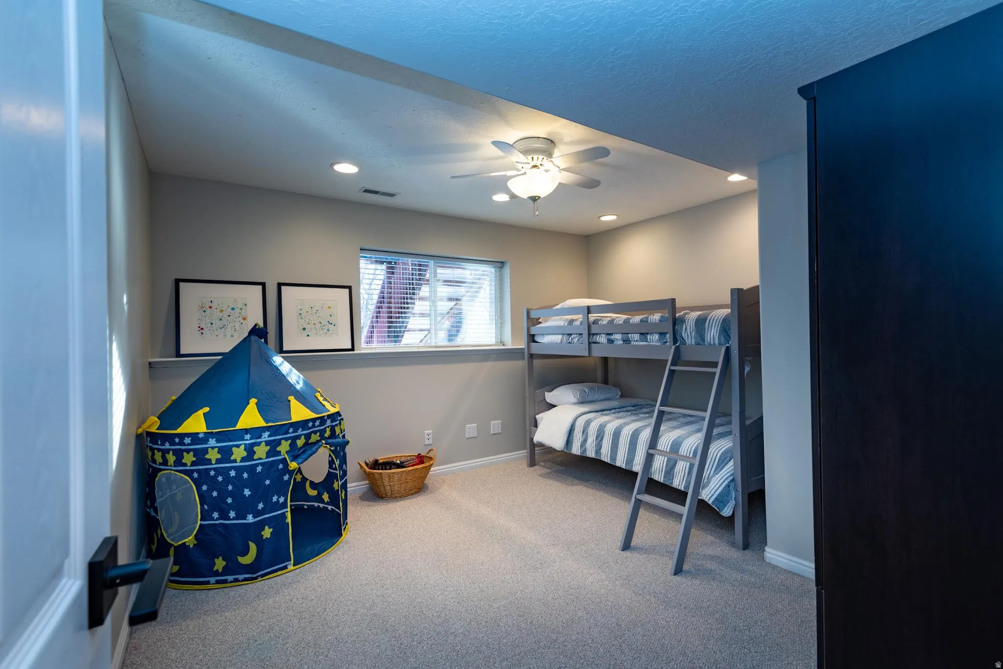 Carpeted room featuring a ceiling fan, recessed lighting, and a window with blinds